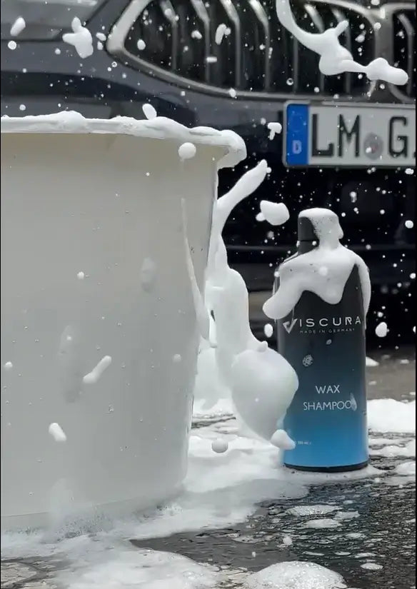 VISCURA Wax Shampoo bottle with foamy bubbles next to a cleaning bucket for car care.